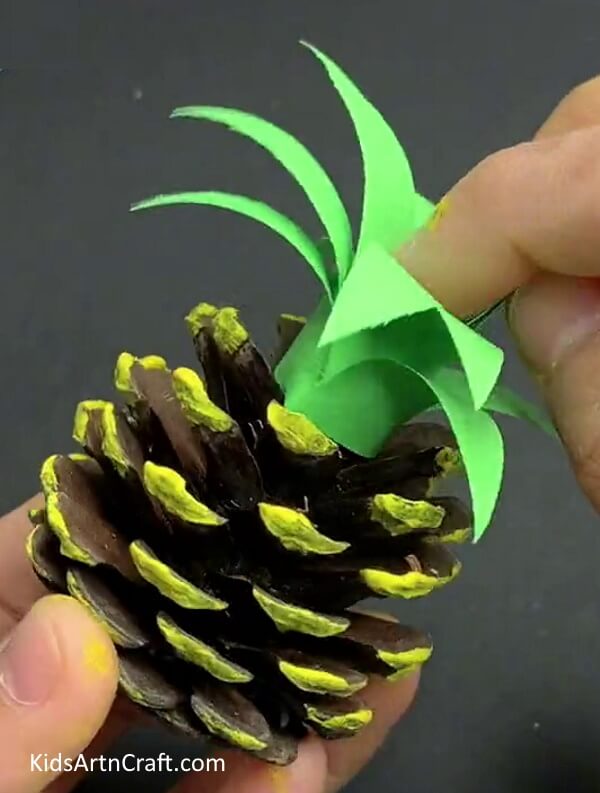 Pasting Leaves - A Comprehensive Tutorial for Kids on Crafting a Pineapple Pine Cone