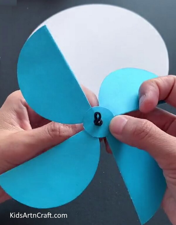 Inserting a Thread - Demonstration on how to assemble a Summertime Paper Fan for Juveniles