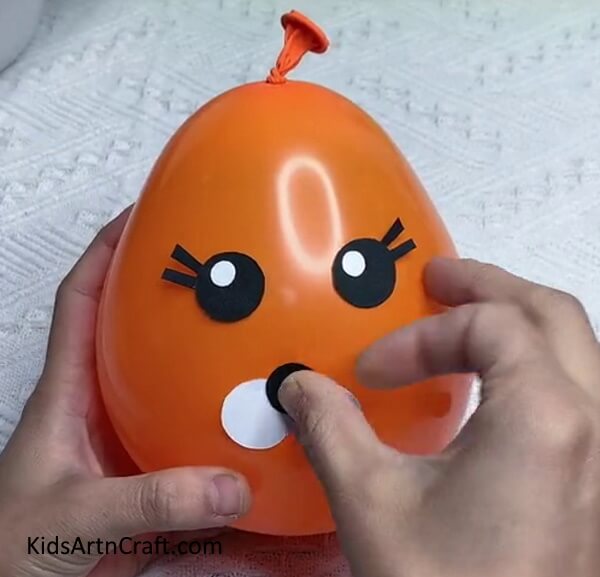 Cut a Small Black Circle To Complete The Mouth-Here is how to make a Tiger Balloon for little ones 