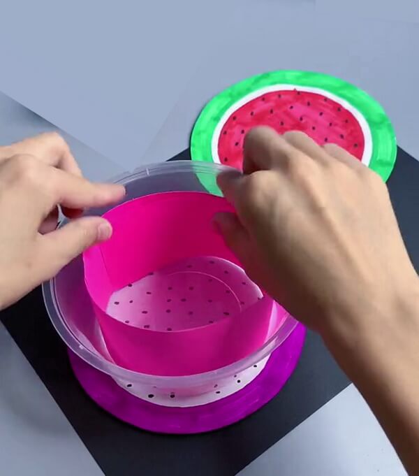 Putting A Pink Paper In Plastic Container - Detailed instructions to make Watermelon crafts