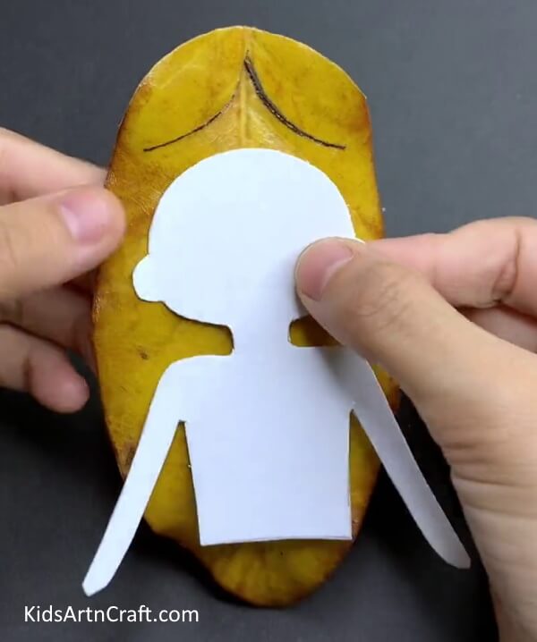 Placing Paper Body Shape On Leaf - Captivating Drop Leaf Puppet Art & Design Thought For Children