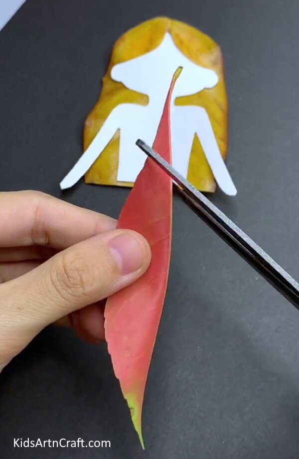 Cutting Top Of Red Folded Leaf - An Enticing Leafy Doll Artwork & Craft Concept For Little Ones