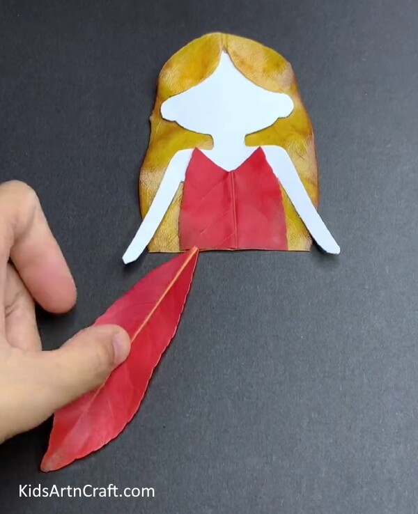 Pasting Red Leaf To Make Dress - A Pretty Leafy Doll Art & Craft Proposal For Minors