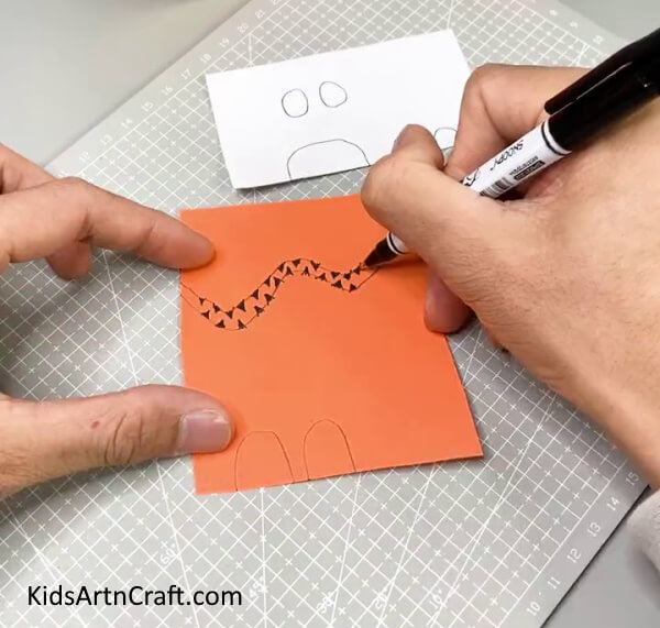 Drawing The Tiger Body Parts On The Orange Paper - Charming Tiger Paper Cup Activity For Little Ones 