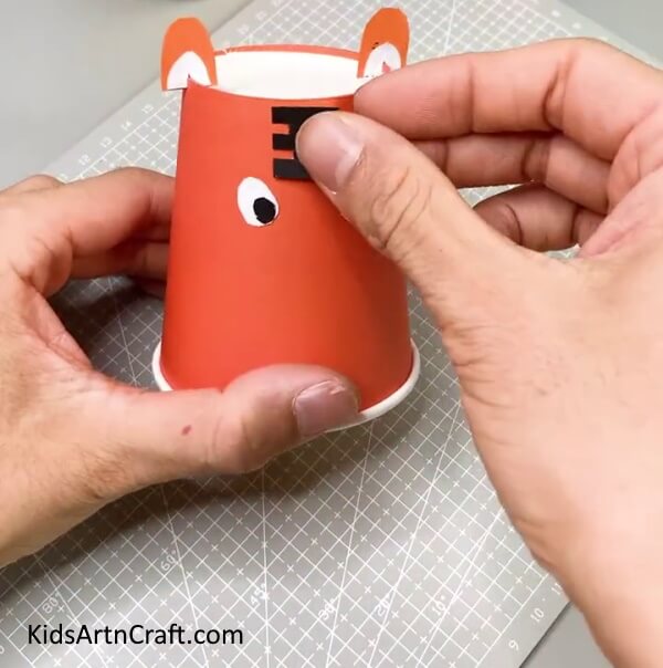 Pasting The Tiger Pattern And The Black Circles - Endearing Tiger Paper Cup Activity For Children 