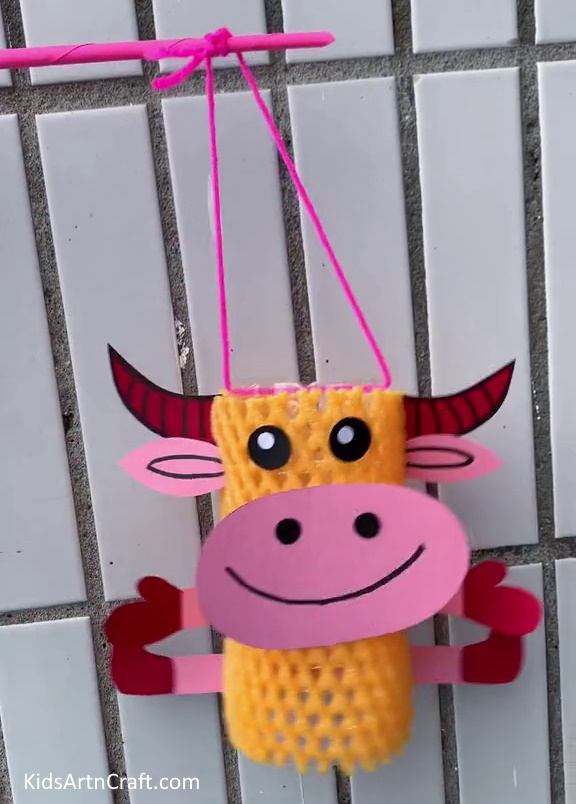 Final Look Of The Cow Craft! - A homemade bovine craft constructed with a net of fruit-foam and a plastic container.