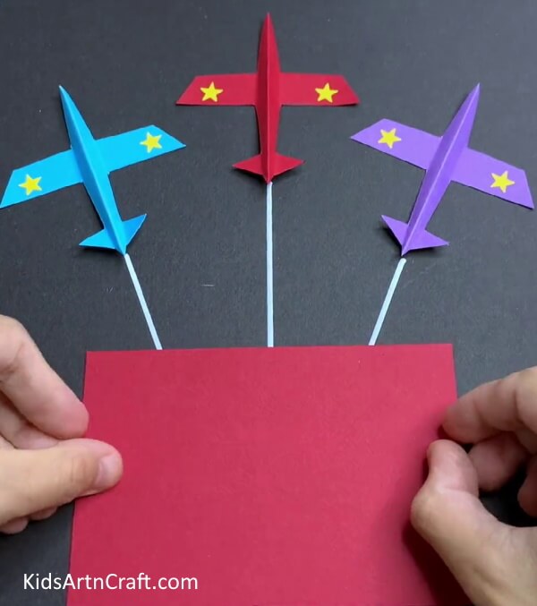 Adding A Red Flag To The Airplanes - Create a simple paper airplane with this straightforward tutorial created for children. 