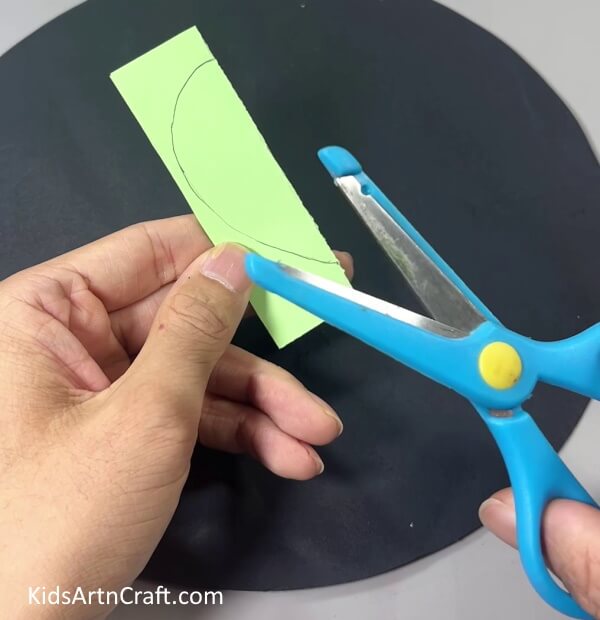 Cutting Drop Shape Out Of Paper - Making a paper cactus as a fun activity for kids.