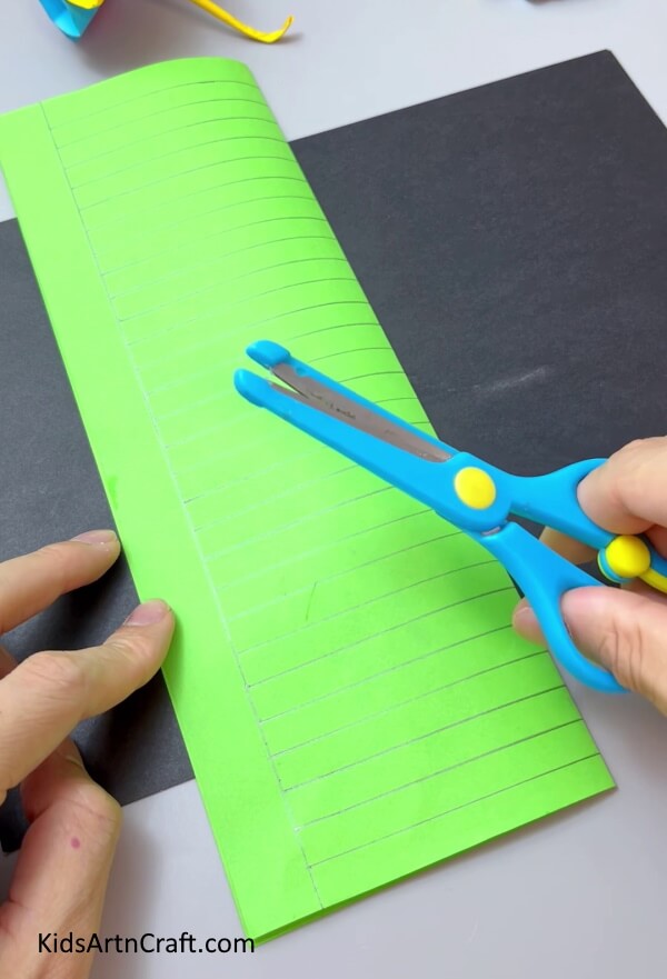 Cutting The Green Strips - A Simple Paper Flower Project for Kindergartners