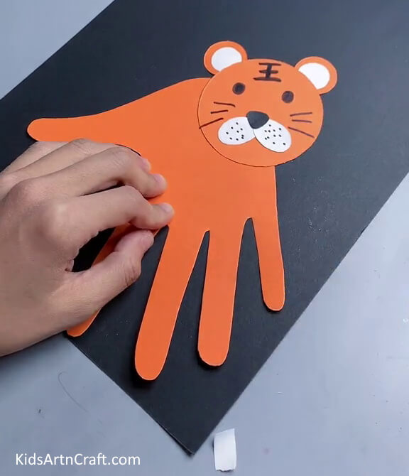 Drawing Stripes And Whiskers Of The Tiger- A Handprint Tiger craft that is perfect for kids.