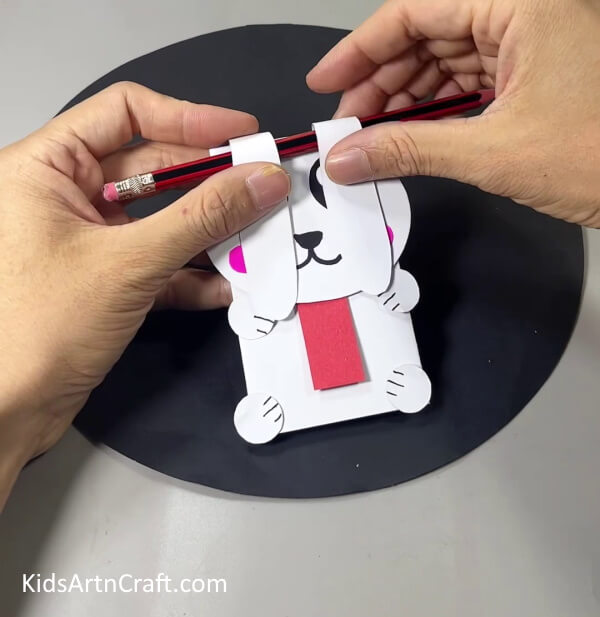 Folding Ears Using A Pencil - Kids can produce an adorable paper bunny craft by hand.