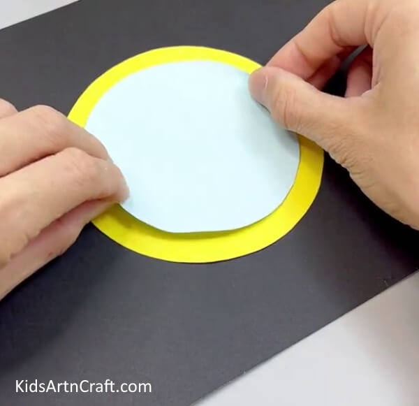 Pasting Blue Circle On Yellow Circle - Build a Butterfly Out of Paper - An Easy Exercise for Youngsters