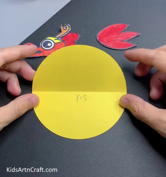 Cutting A Yellow Circle Make a paper Chinese dragon craft with the help of the little ones