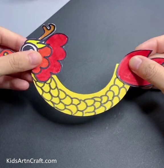 Pasting The Mouth And Tails Let the children make their own paper Chinese dragon craft