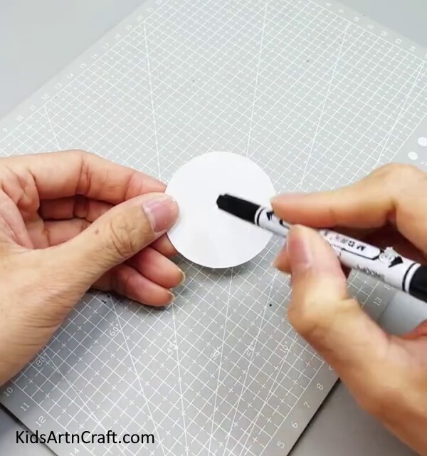 Cutting A Circle Out Of White Paper - Making a Bunny Out of Reused Paper Cups for Little Ones