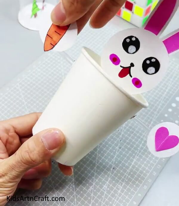 Pasting Carrot and Heart On Side Straws - Formulating a Bunny from Recycled Paper Cups for Little Ones