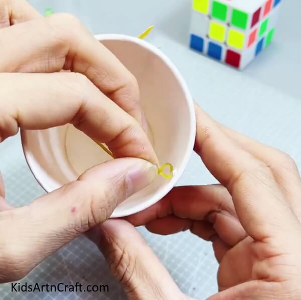 Taking Out The Rubber Band From The Other Side Of The Cup - Make a Reusable Paper Cup Crab Craft With Detailed Step by Step Instructions