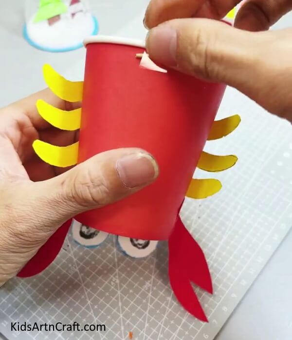 Apply Tape On Both The Sticks - Crafting a Reusable Paper Cup Crab With Step by Step Directions