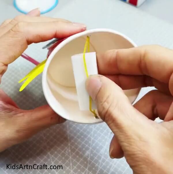 Placing A Paper Between Rubber Band - Step by Step Directions on Crafting a Reusable Paper Cup Crab