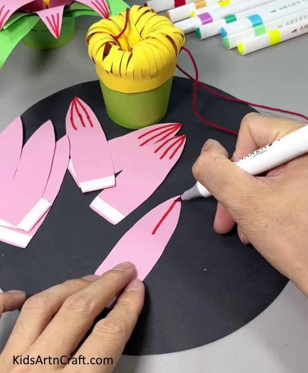Drawing Details On Petals Using Red Marker - Instructions for Crafting a Paper Flower Hanging Art Piece