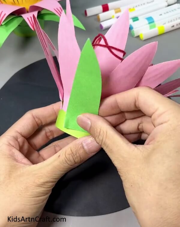 Pasting Green Paper Leaves - Learn How to Make a Paper Flower Hanging with This Step-by-Step Guide