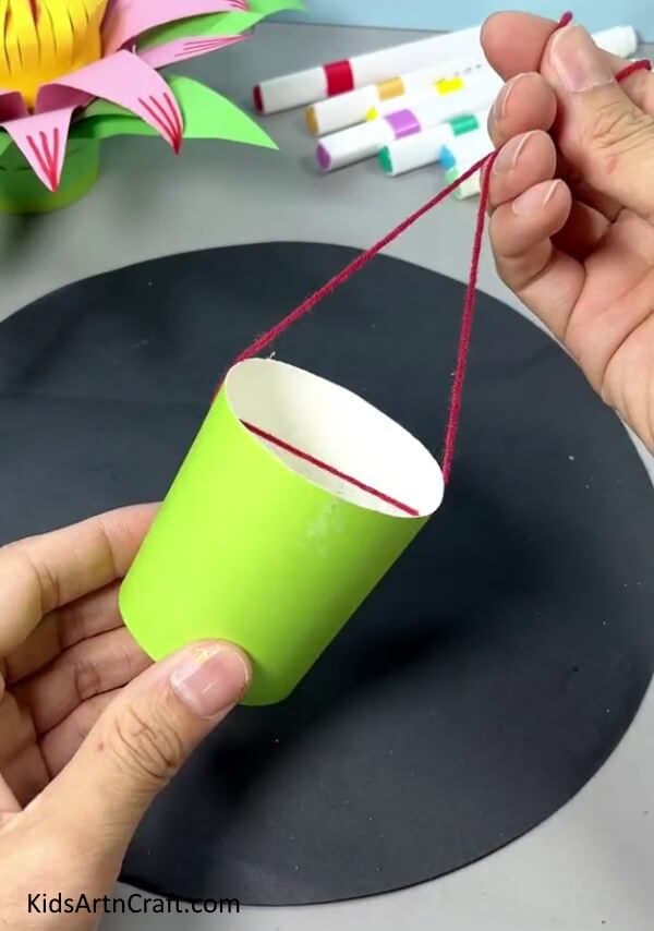 Attaching Thread To The Paper Cup - Follow This Step-by-Step Tutorial to Make a Paper Flower Hanging