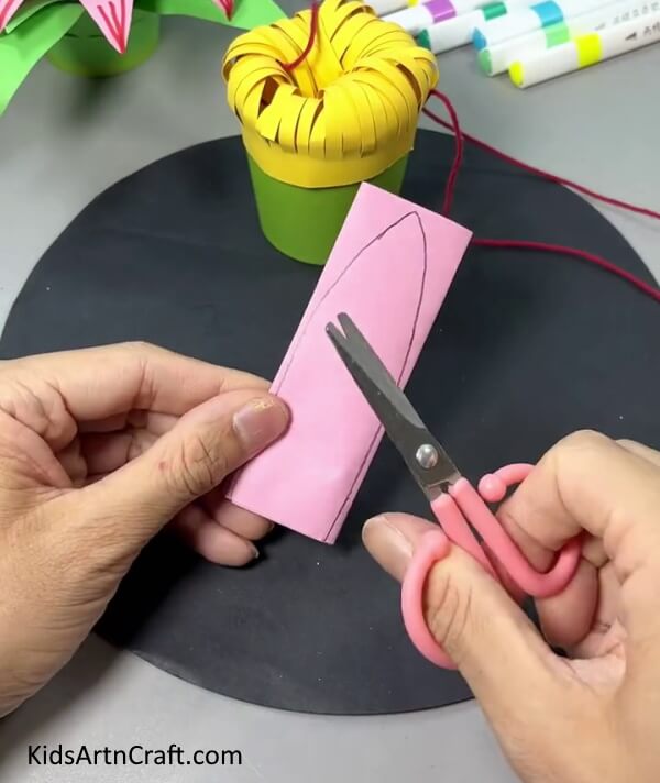 Drawing Petal Shape On Pink Paper - DIY Tutorial for Making a Paper Flower Hanging