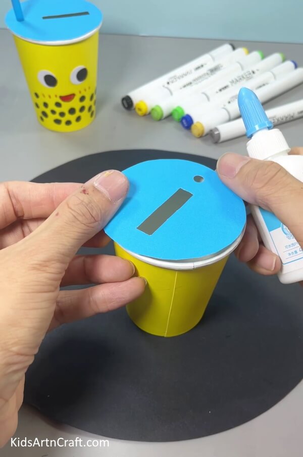 Pasting Circle On Paper Cup - Create your own customized mug craft with this straightforward project.