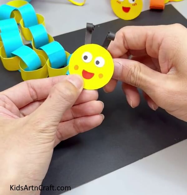 Pasting Face To Body - A kindergarten paper worm craft that is easy to assemble.