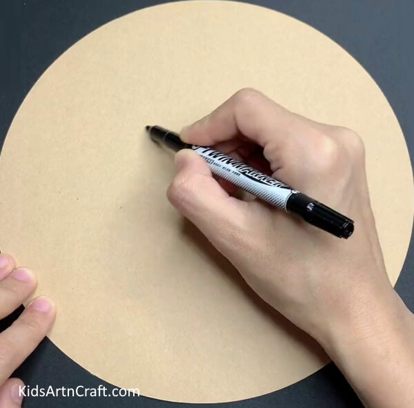 Getting A Circular Cardboard And A Black Marker- Crafting Sheep Out of Recycled EggShells 