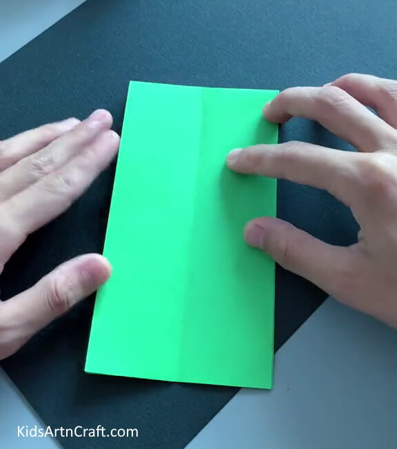 Folding it in Half From the Shorter Side - Develop a paper toy craft for entertaining kids.