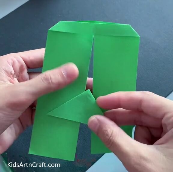 Putting the Small Triangle in Between the Paper - Bringing children joy by creating a paper toy craft.