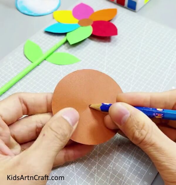 Cutting Out A Big Brown Circle - It is easy for kids to make a colorful and simple paper flower. 