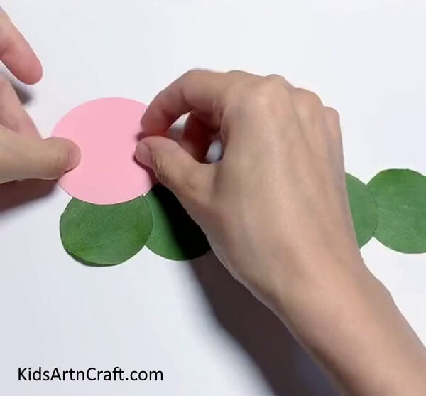 Pasting A Pink Paper Circle - Crafting a Caterpillar with Colorful Leaves