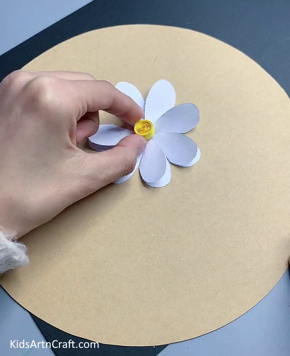 Sticking the Pistil on the Flower - Producing paper flowers is easy for minors. 