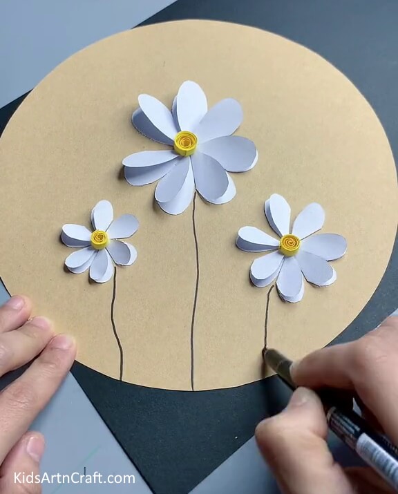Completing the Stems of all the Flowers - Constructing paper blooms a cinch for minors. 
