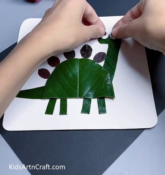 Pasting Eyes - An Easy Dinosaur Craft For Kids Employing Fresh Leaf