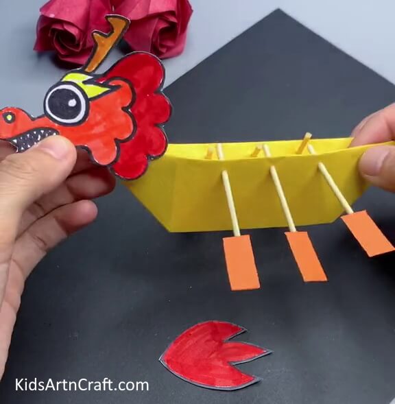 Pasting Head On Bow Of Boat - Crafting a Dragon Boat with paper - fun for kids 