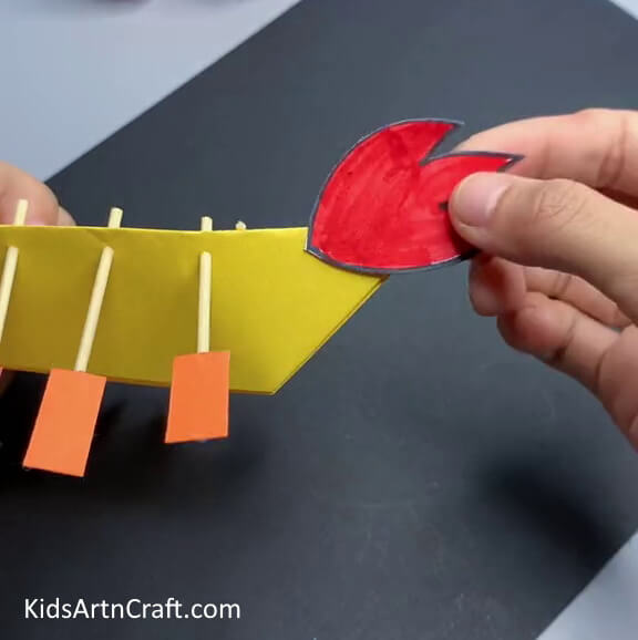 Pasting Tail on Boat - A tutorial to make a Dragon Boat with paper for youngsters 