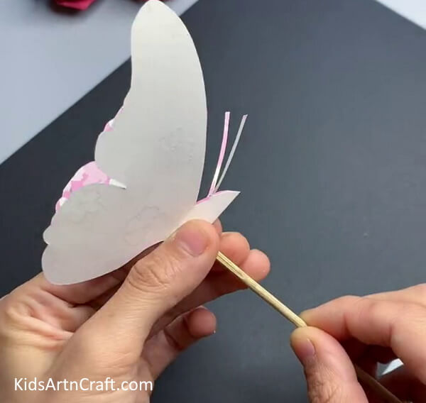 Pasting The Wooden Stick - Alluring Paper Butterfly Craft Concept For Little Ones To Make 