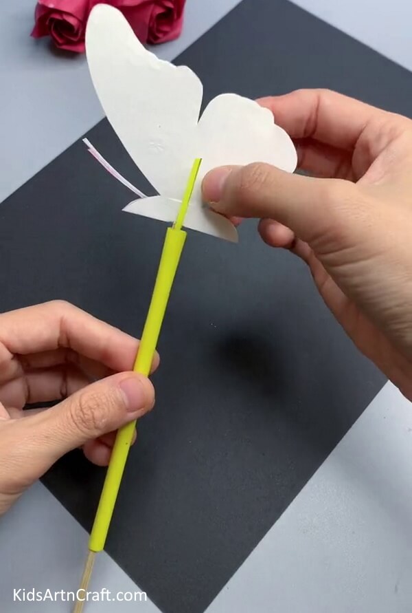 Inserting The Straw Inside The Stick - Pretty Paper Butterfly Craft Scheme For Toddlers To Produce 
