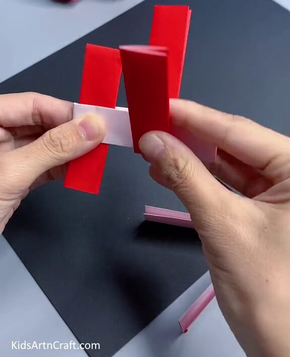 Attaching Another Red Strip Vertically - A Comprehensive Guide to Creating a Basic Paper Toy With Step by Step Directions