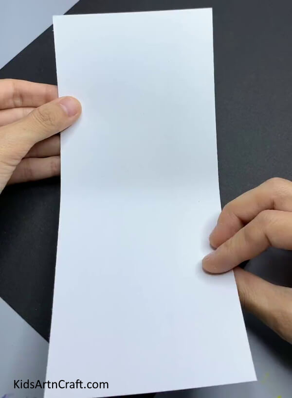 Taking A Long White Paper Rectangle - A fun and straightforward snowman paper craft activity for little ones in Kindergarten.