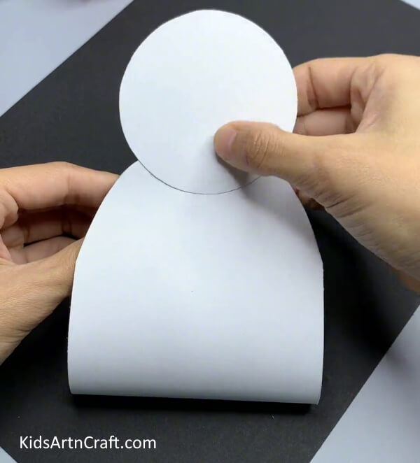 Pasting A White Circle - An easy snowman paper craft project for Kindergarteners.