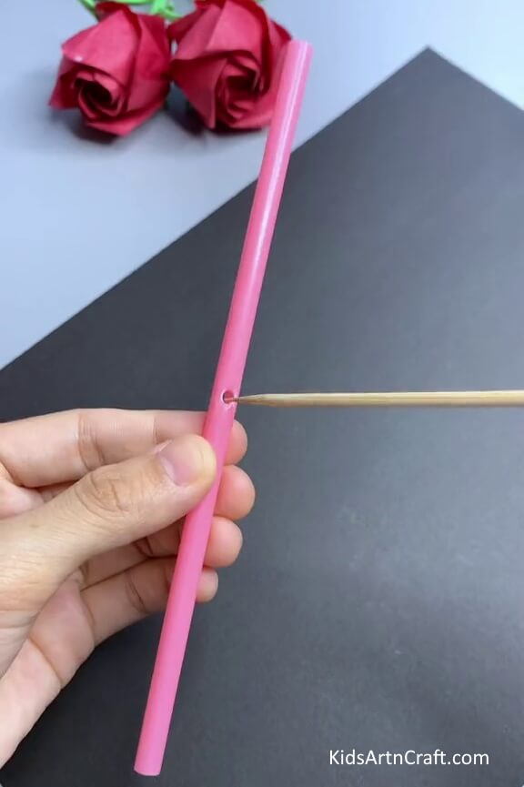 Inserting Wooden Stick Into A Plastic Straw -Children will have a blast constructing a straw toy craft.