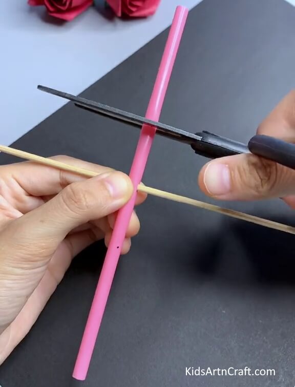 Making Cuts On The Pink Straw -Kids will enjoy creating a straw toy craft project.