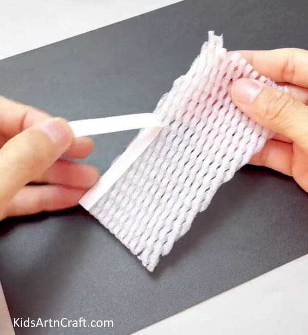 Applying a Double-Sided Tape - Making a Homemade Corn Craft Using a Fruit Foam Net