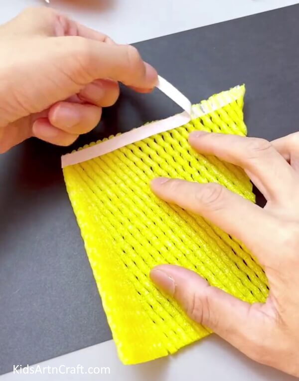 Applying Double-Sided Tape - Utilizing a Fruit Foam Net to Construct a Corn Craft