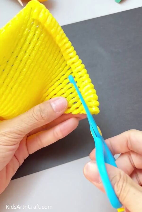 Rolling And Cutting The Foam Over  - Home-made Corn Craft With the Help of a Fruit Foam Net