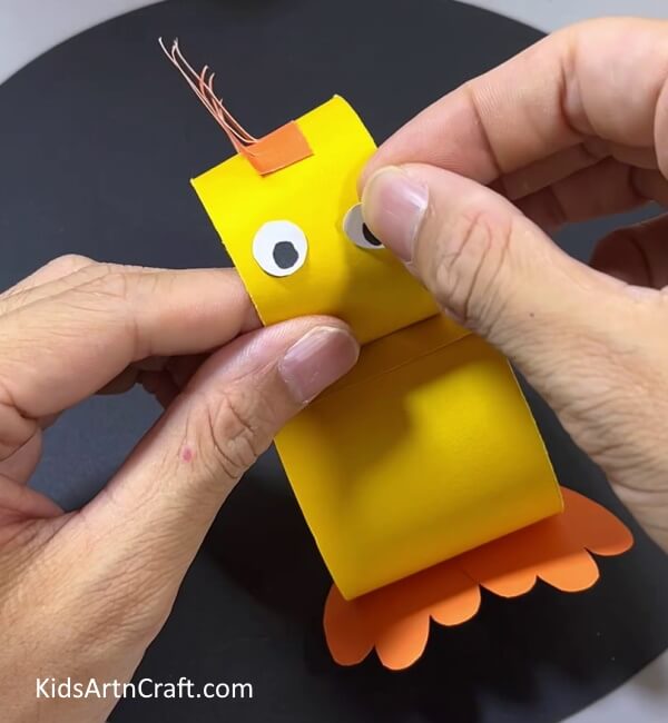 Pasting Eyes - An enjoyable paper duck toy craft project for children. 